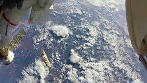 A UFO flying close to the International Space Station was returned by astronauts repairing the space shuttle (Video)