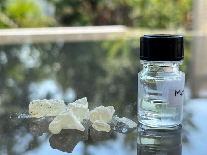 Dammar resin, an ingredient in embalming, next to a bottle of the ancient scent recreated by perfumer Carole Calvez based on scientific analyses. Credit: Barbara Huber