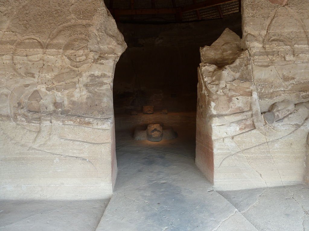 The entrance into the inner chamber of the Eagle Warriors Temple in Malinalco. The temple has a long extended bench that covers half of its inner chamber. There are carved sculptures on the bench of eagles and a jaguar. In the center of the inner chamber there is a giant carved eagle on the floor. Some believe the centre eagle would be used as an altar or throne. Surrounding buildings around Malinalco contained several murals depicting the life of a warrior. In additions there were murals of dancing eagles and jaguars within structures in Malinalco.