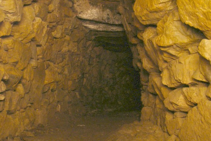 The main, curved, chamber of the Halligye Fogou at the Trelowarren Estate, Cornwall. Photo taken with a long exposure and illuminated by a moving torch beam.