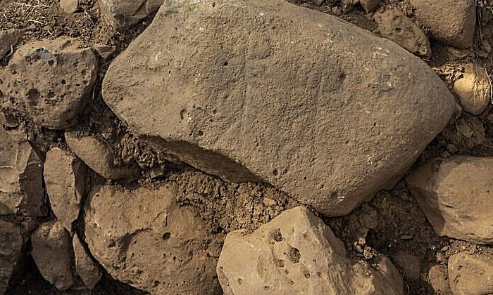 The engraved stone discovered in the excavation at Hispin in the Golan, which dates to circa 11th century BCE, and could be the earliest evidence of the biblical 'Geshurites.' (Yaniv Berman, Israel Antiquities Authority)