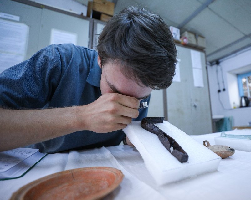 Archaeologist Jakob Krasel from Freiburg University works on a scraping tool called strigilis discovered in the tomb of Markos, known as 