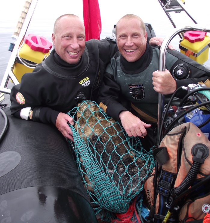 The Barnwell brothers with the ship's bell. Credit: Norfolk Historic Shipwrecks